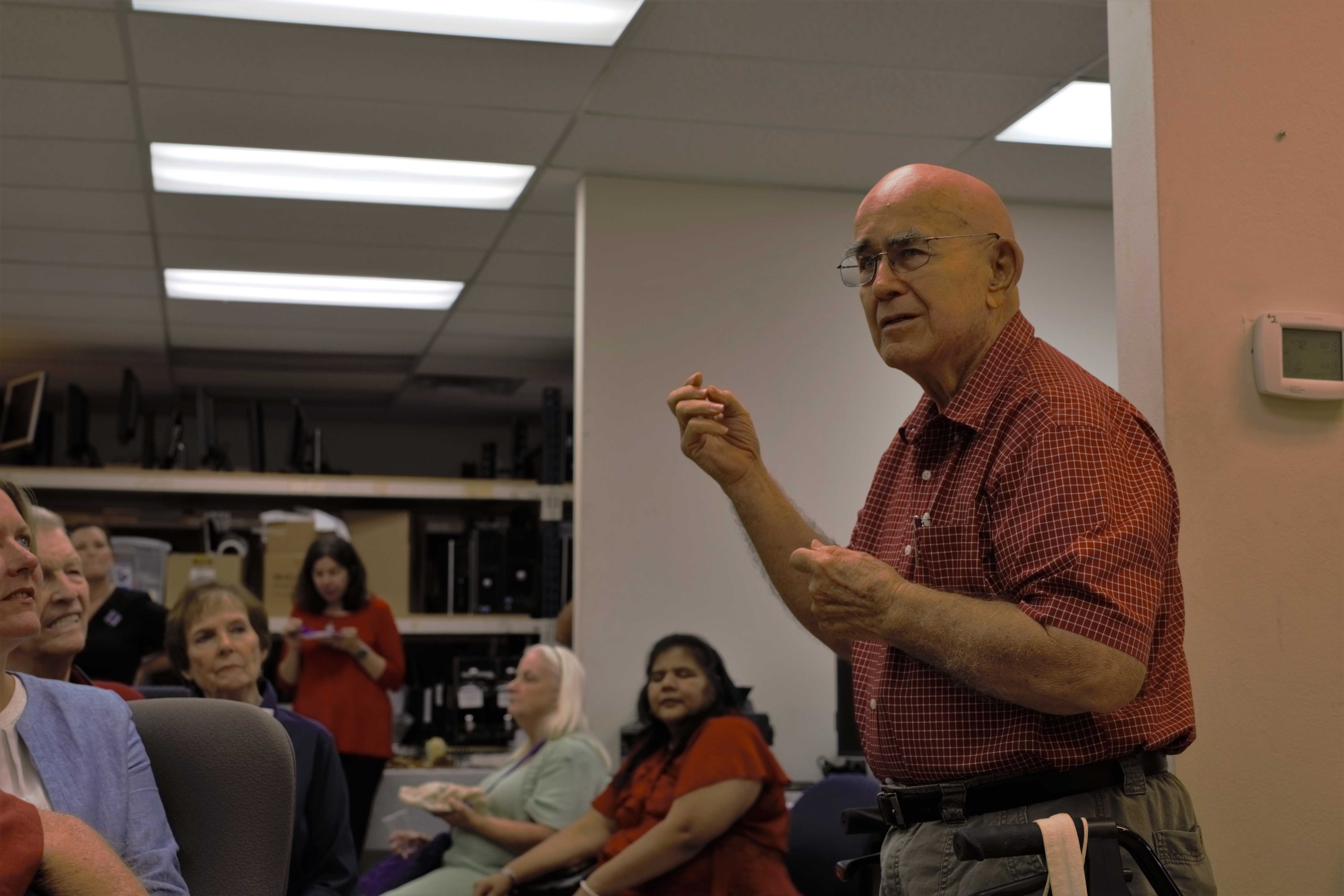 Volunteers, community members, and others participate in the presentation of the 10,000th computer.