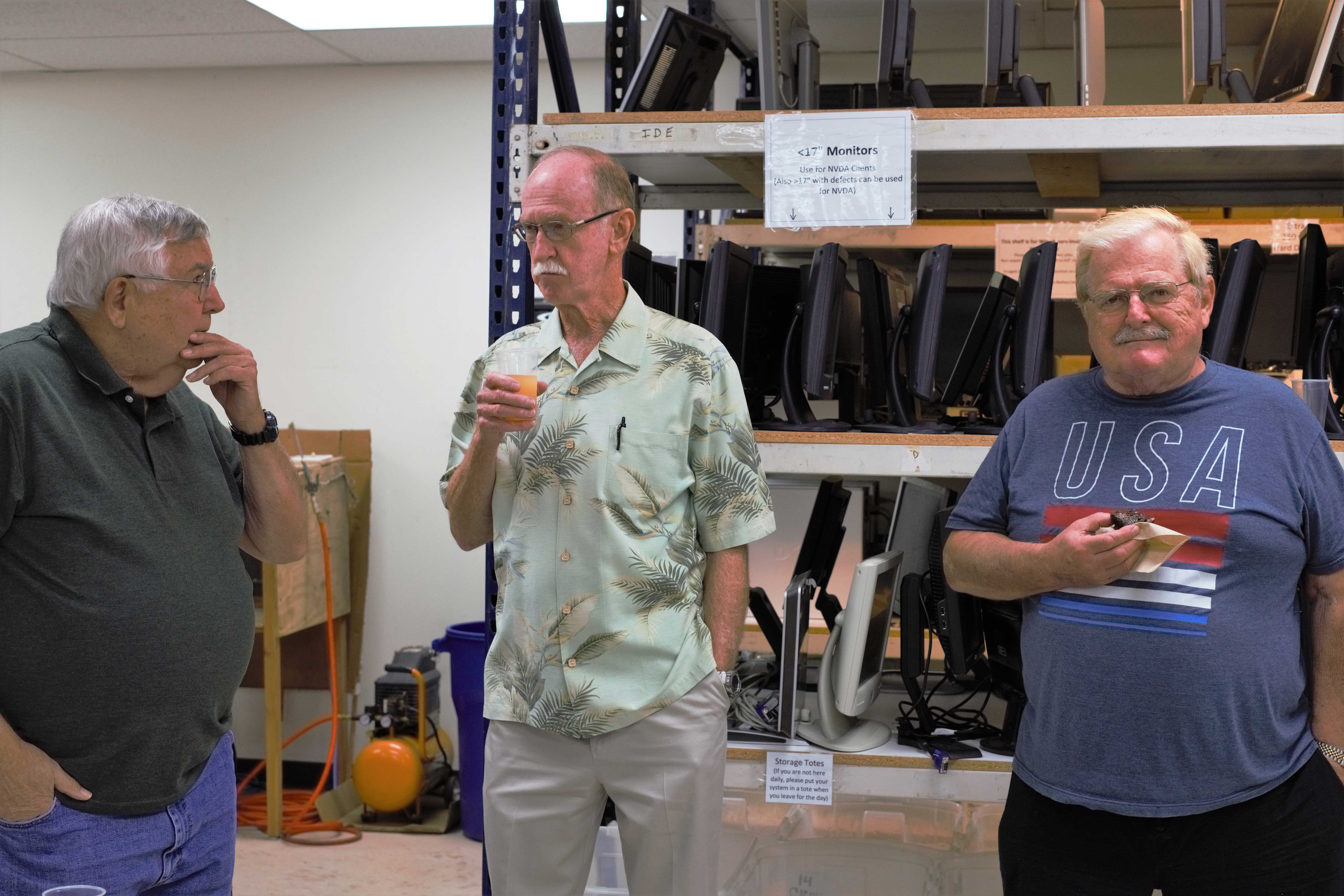 Volunteers, community members, and others participate in the presentation of the 10,000th computer.