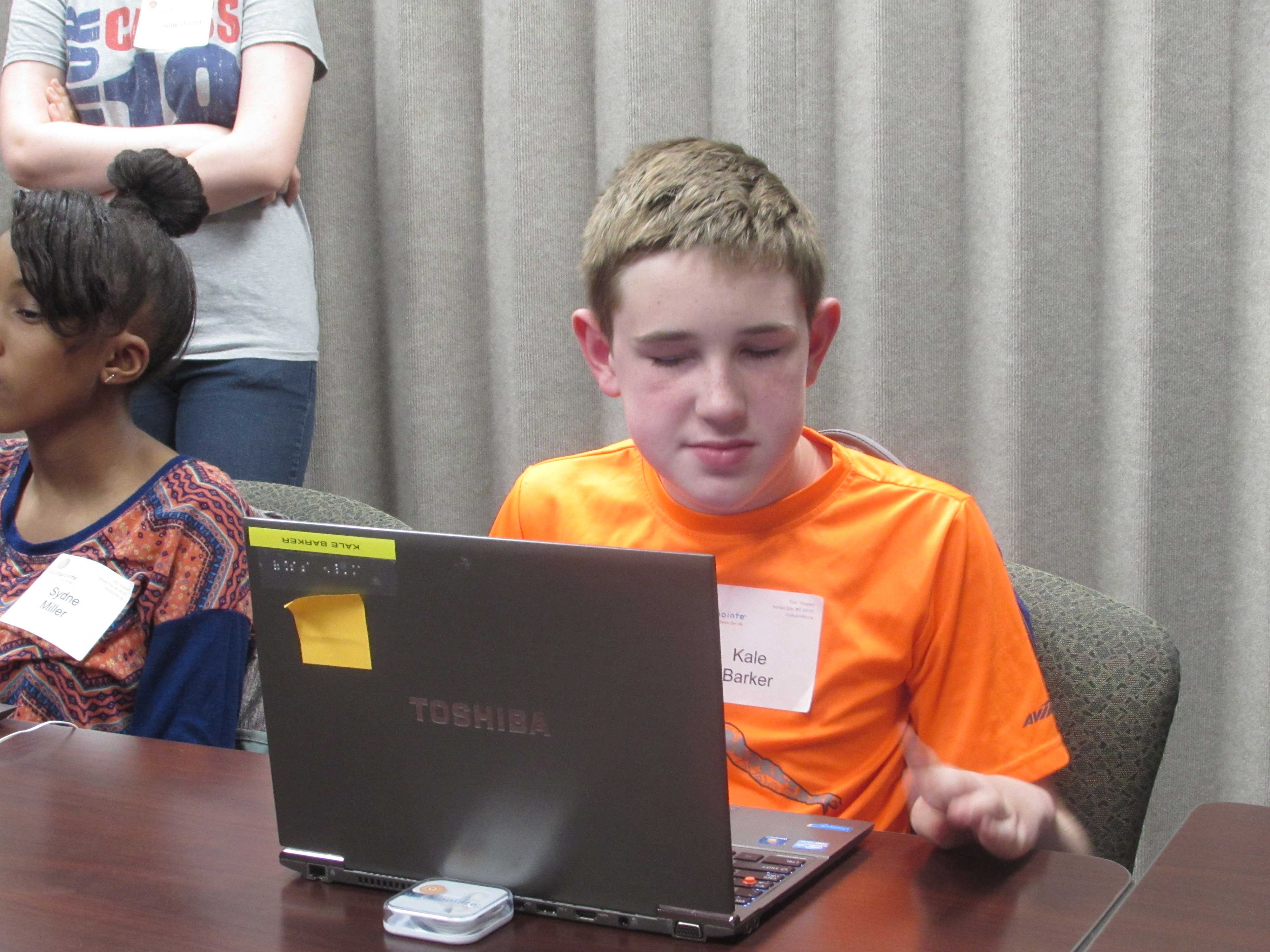 Students at the Alphapointe camp learning how to use their laptops