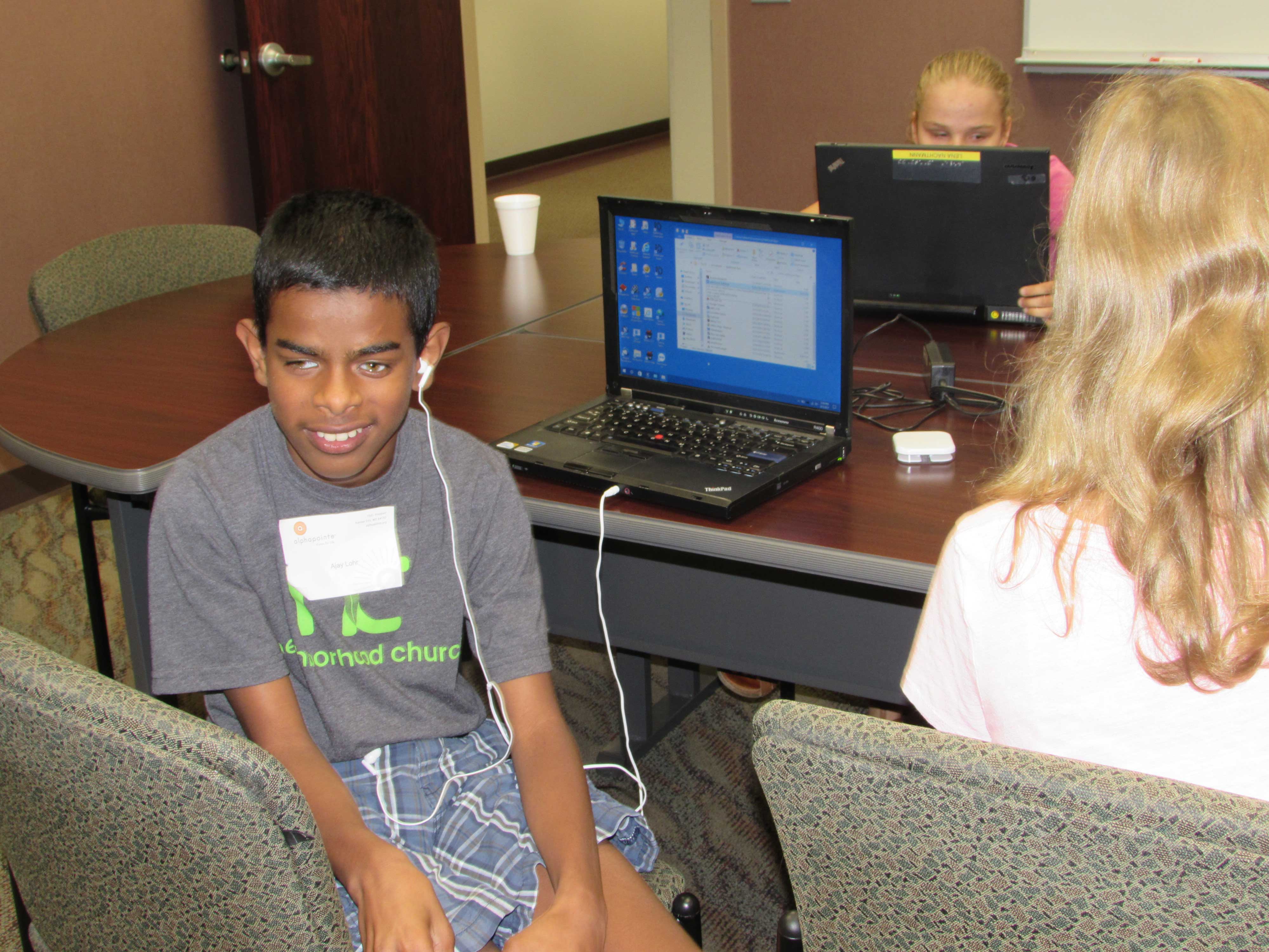 Students at the Alphapointe camp learning how to use their laptops