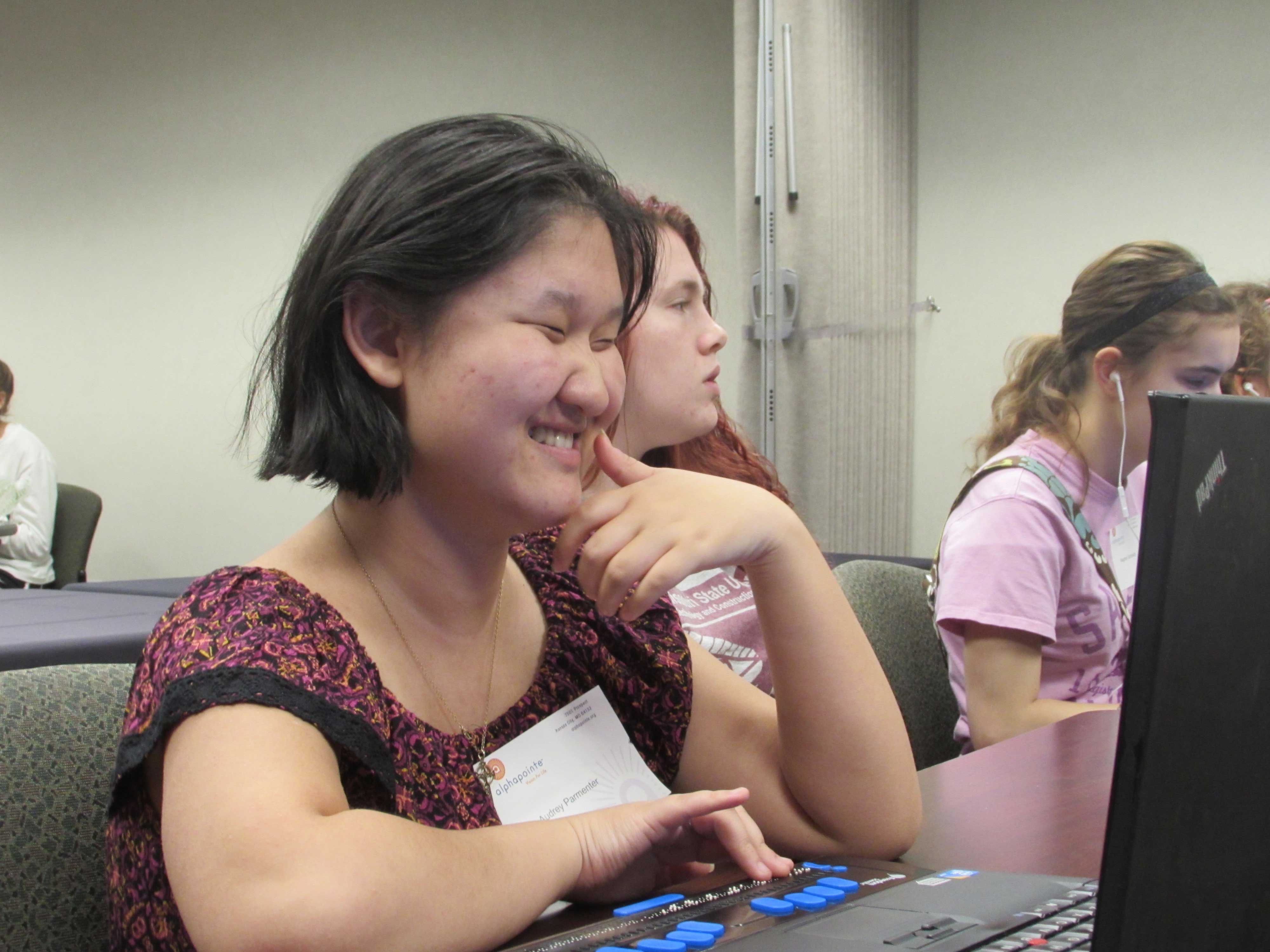 Students at the Alphapointe camp learning how to use their laptops