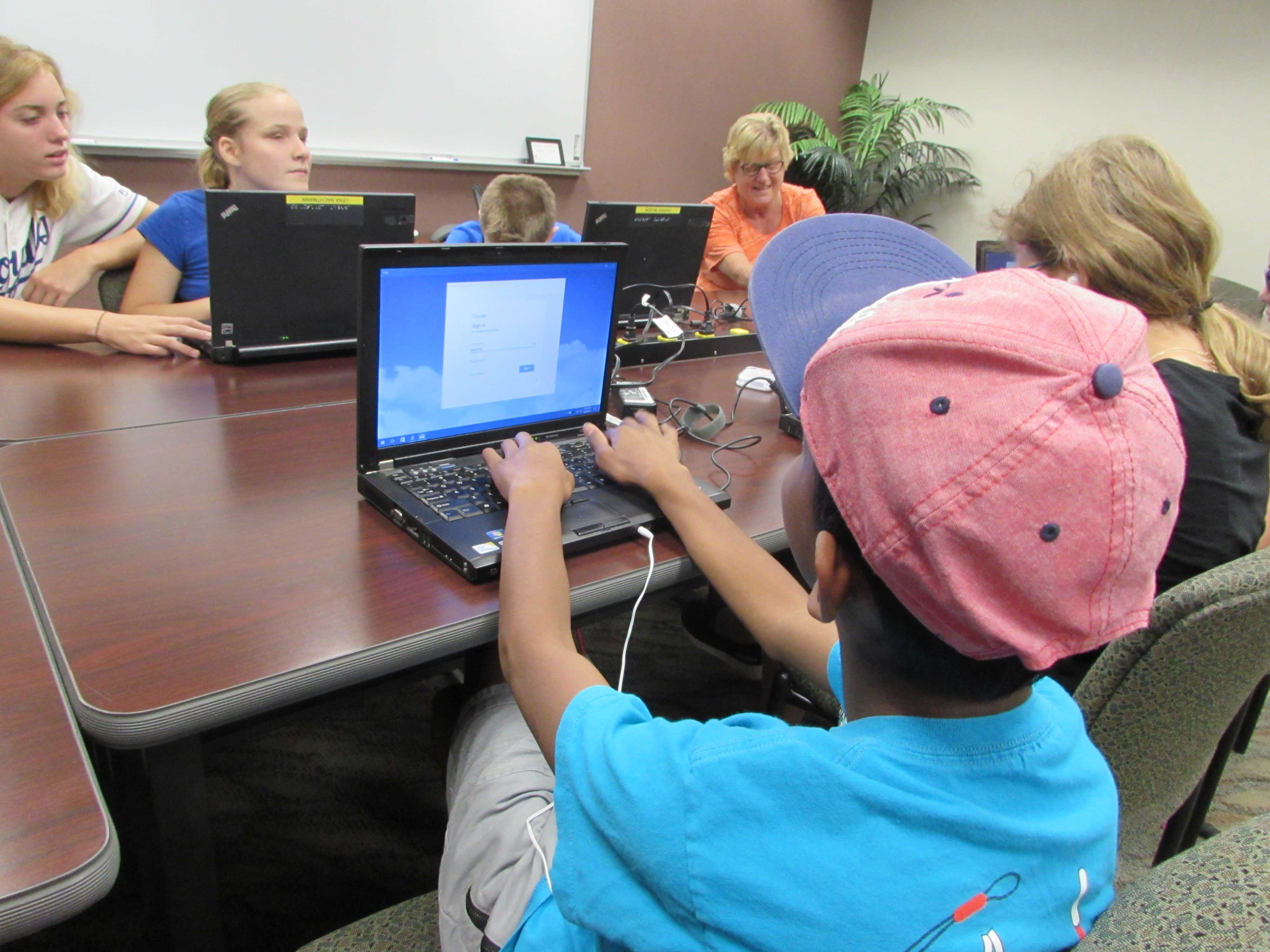 Students at the Alphapointe camp learning how to use their laptops