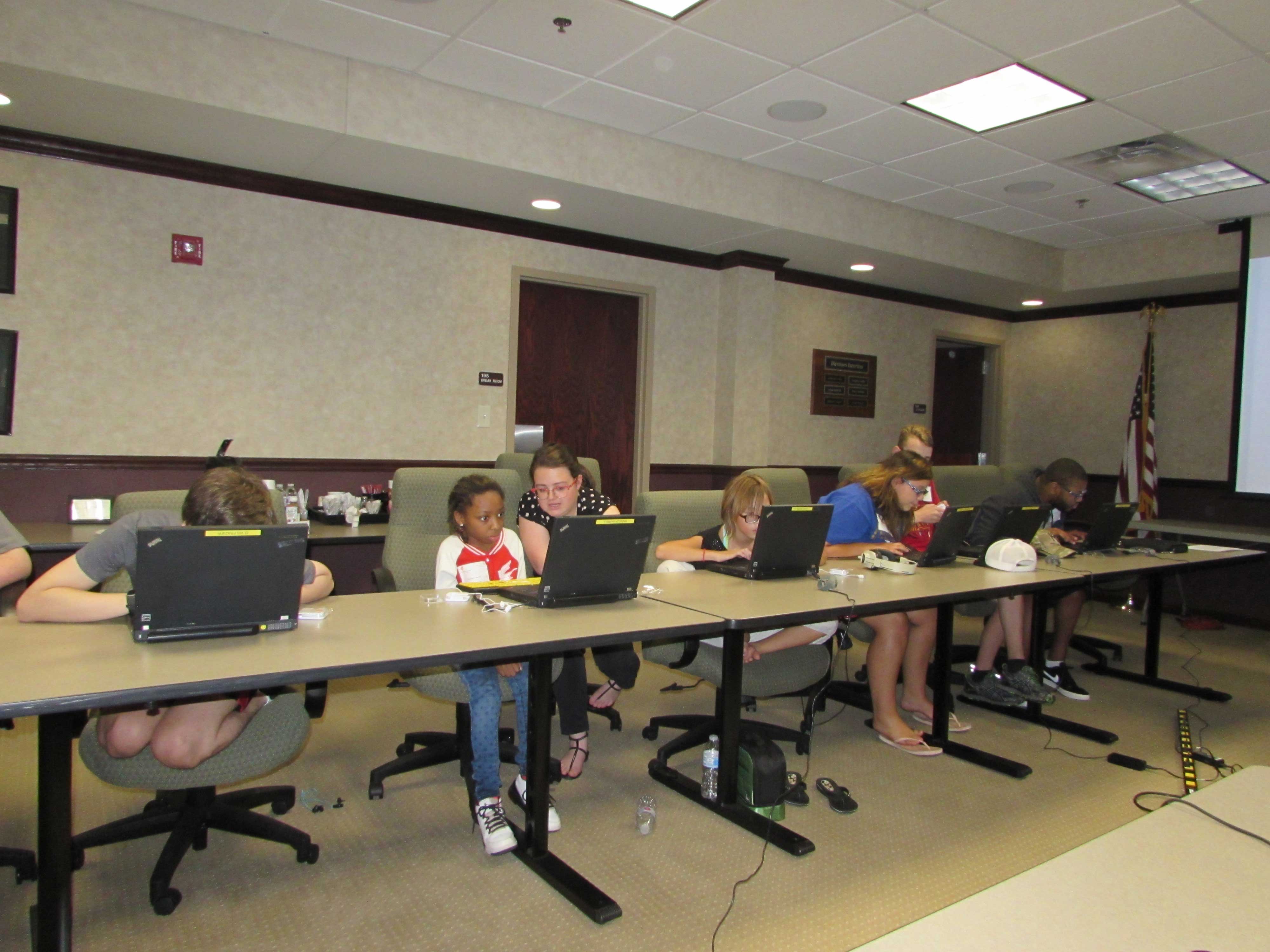 Students at the Alphapointe camp learning how to use their laptops