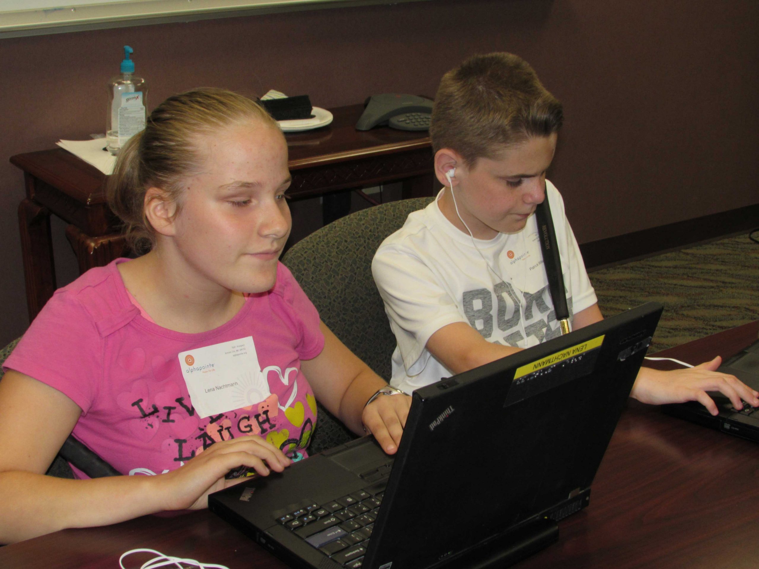 Students at the Alphapointe camp learning how to use their laptops